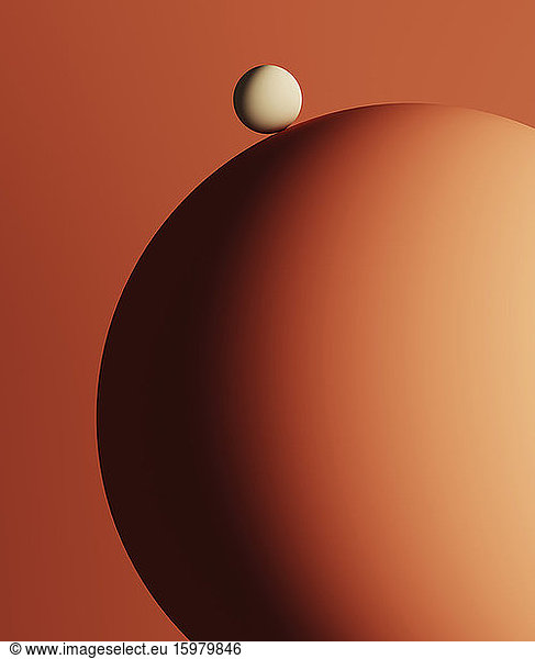 Three dimensional render of small sphere on top of large one
