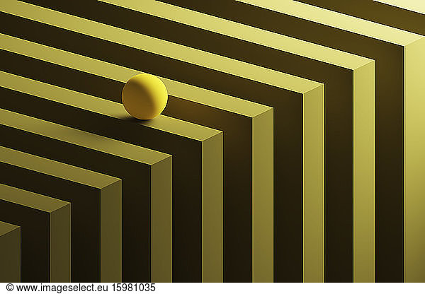 Three dimensional render of small yellow sphere rolling over geometric pattern