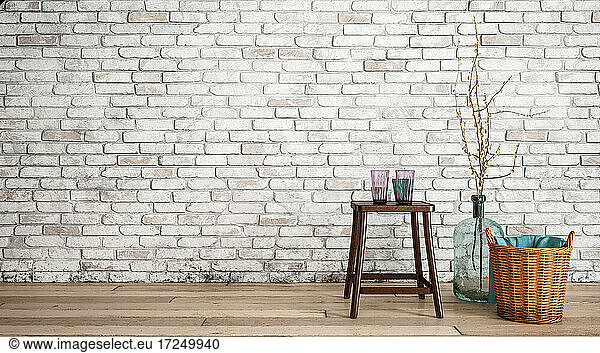 Three dimensional render of stool  basket and bottle with twigs standing in front of brick wall