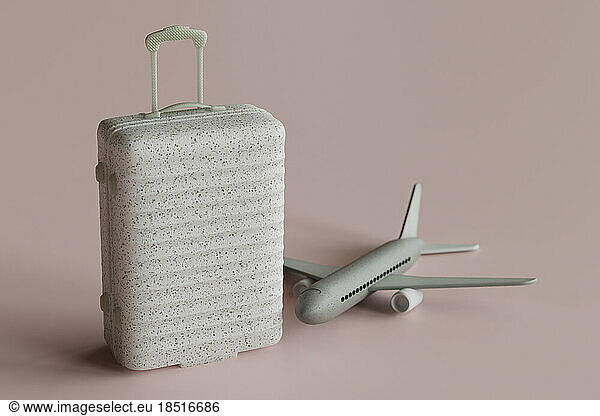 Three dimensional render of suitcase and toy airplane