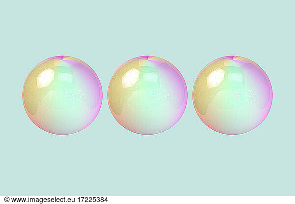 Three dimensional render of three bubbles against green background