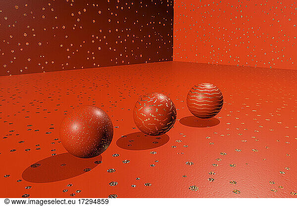Three dimensional render of three red spheres lying against red spotted background