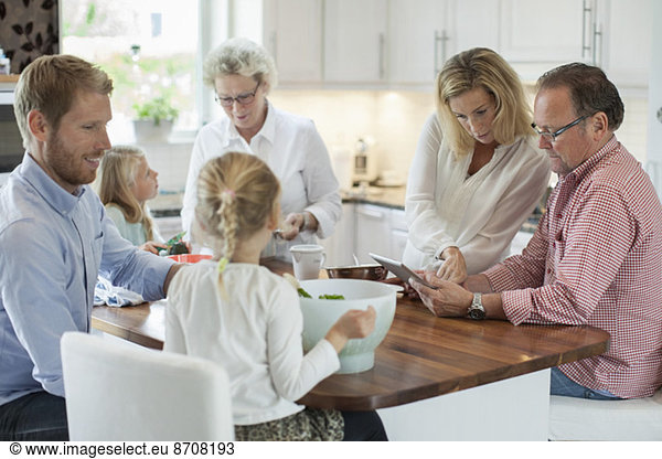 Three generation family preparing food in kitchen