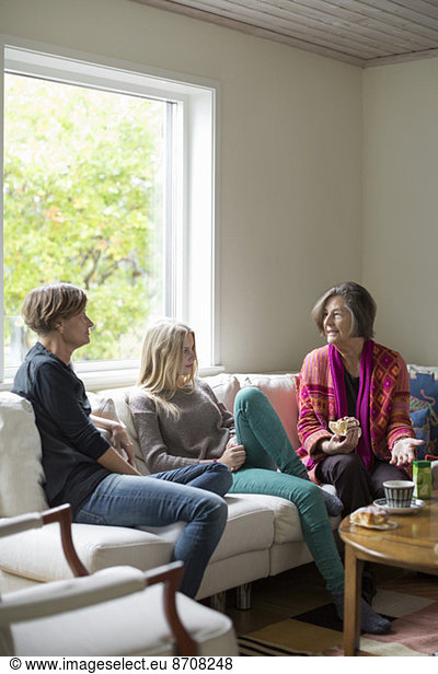 Three generation females spending leisure time in living room
