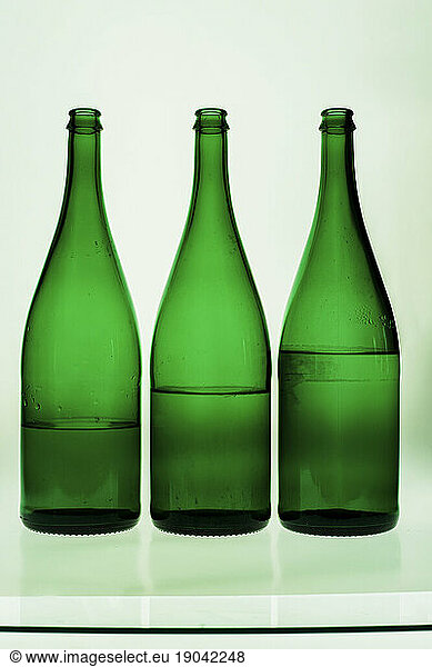 three green water bottles