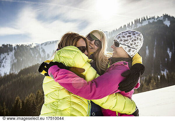 Three happy women hugging in winter landscape  Achenkirch  Austria