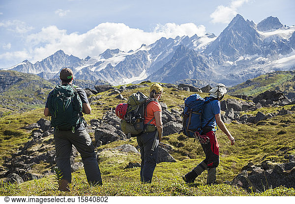 Three hikers enjoy views of Talkeetna Mountains  Alaska
