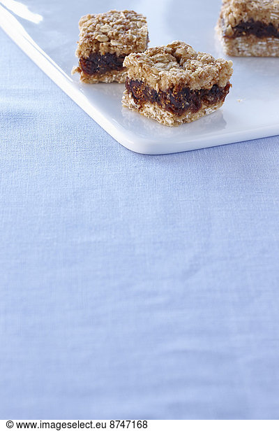 Three Oatmeal Fig Dessert Squares in the top of the frame with Copy Space  Studio Shot