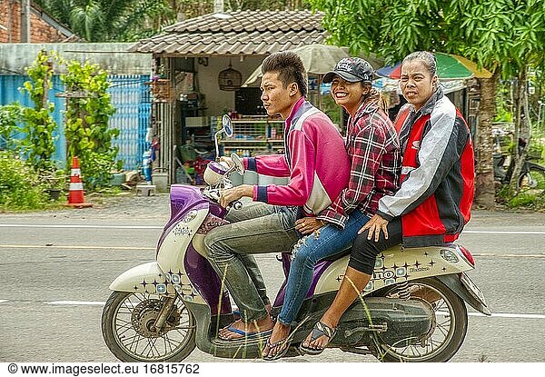 Three on a motor scooter  Satun Province  Thailand.