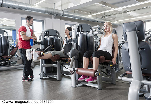 Three people fitness studio man two women sport