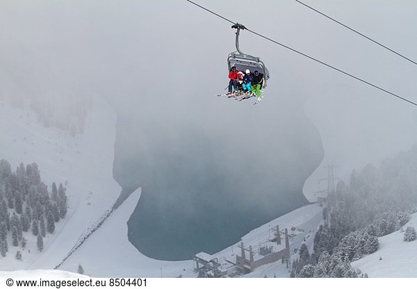 Three people on ski lift in Kuhtai  Austria