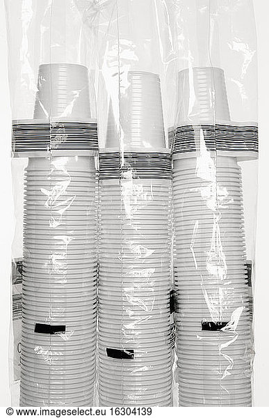 Three stacks of plastic cups wrapped in foil