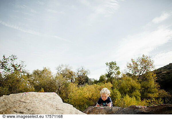 Three Year Old Boy Climbing on Rocks at Mission Trails in San Diego