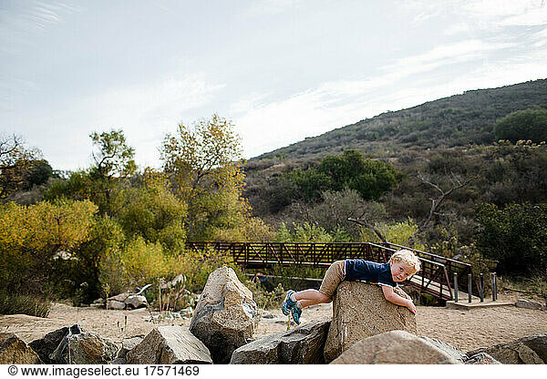 Three Year Old Boy Laying on Rock at Mission Trails in San Diego