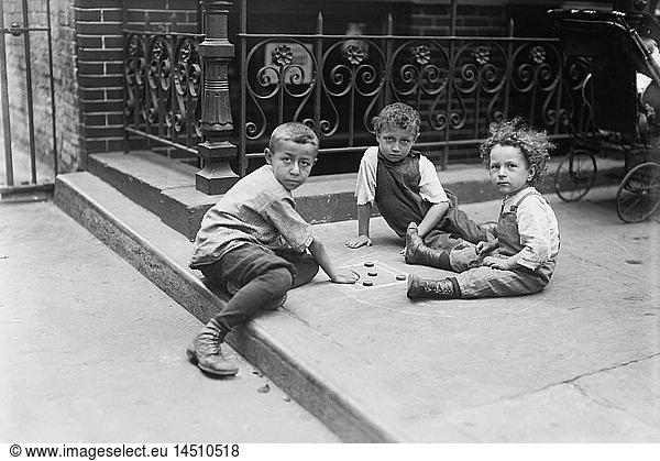 Three Young Boys Playing Game on Sidewalk  New York City  New York  USA  Bain News Service  July 1913