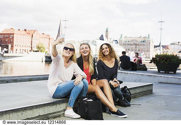 Three young women taking selfie