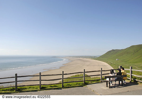 Three youths overlooking the beach and sea at a lookout point  Rhossili Beach  Gower Peninsula  Wales  Great Britain  Europe