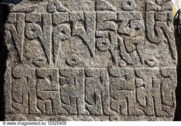 Tibetan script on rocks in the Nepalese Himalayas; Nepal