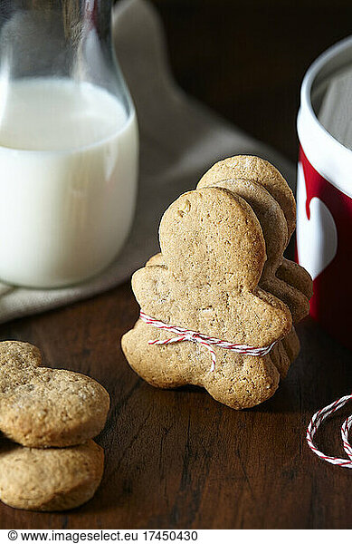 tied up stack of almond gingerbread men with milk