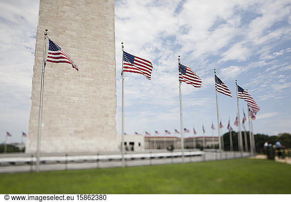 Tilt shift view of flags beneath the Washington Monument in DC.