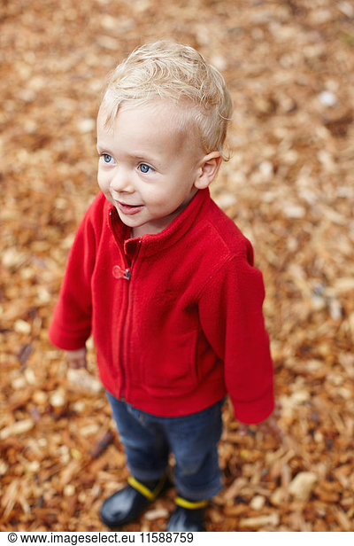 Toddler boy smiling outdoors