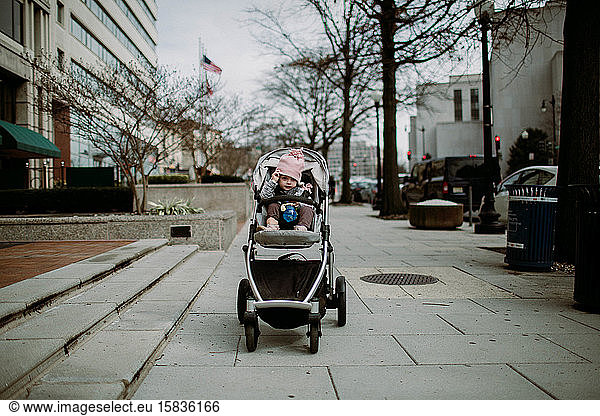 toddler in stroller on sidewalk in Washington DC winter