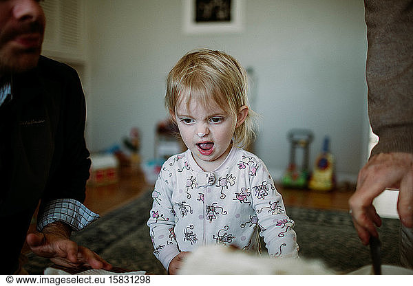toddler makes silly face with ice cream on nose
