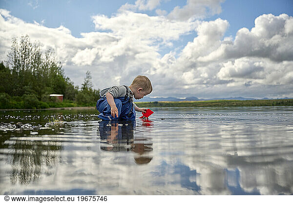 Toddler playing in tranquil lake