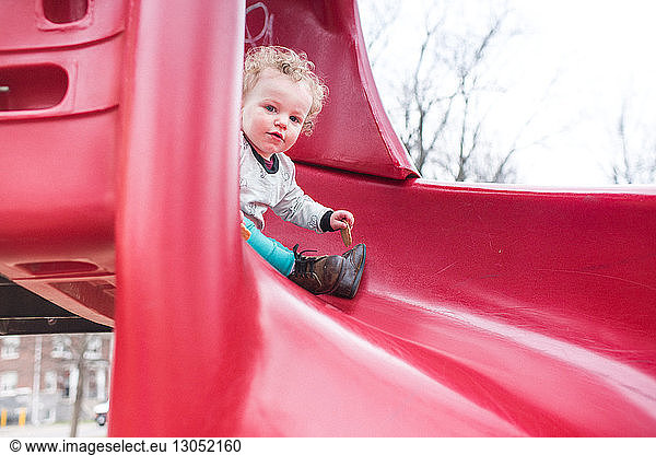 Toddler playing on slide