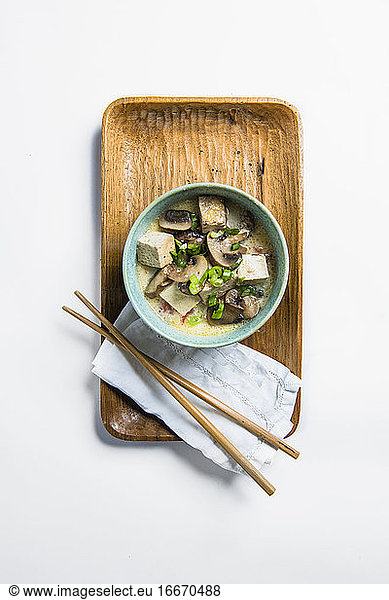 Tofu and Mushroom soup in blue bowl with chopsticks