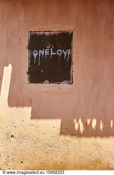 Togo  Motivational text painted on wooden window shutter