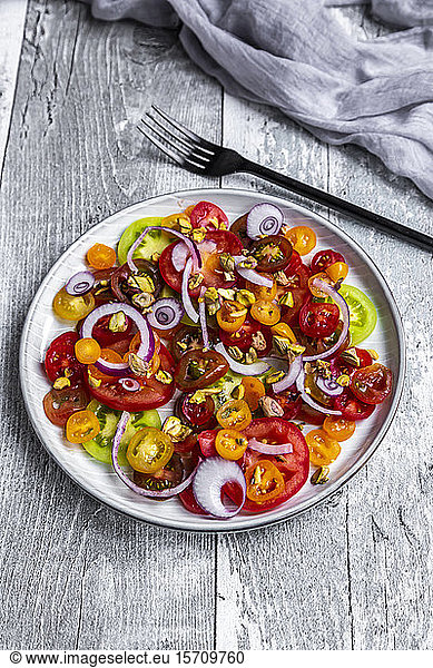 Tomato salad with red onion and pistachios