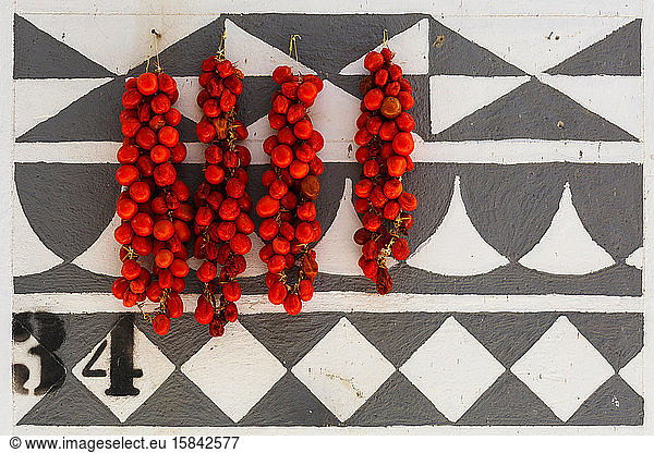Tomatoes drying on a traditionally decorated wall of a house in Pyrgi.