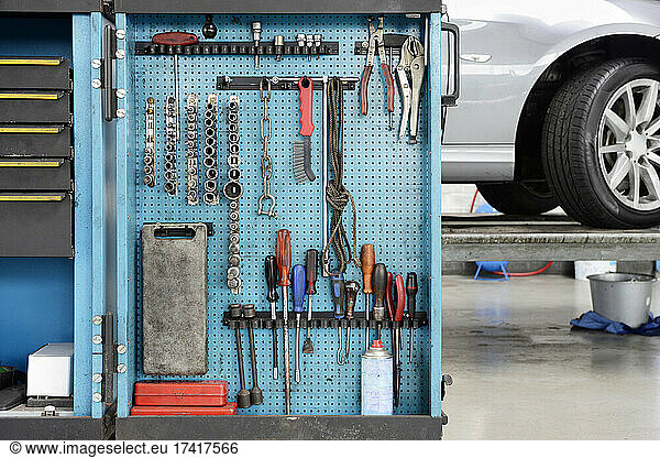 Tools in a cabinet  organised in rows  at an auto repair shop