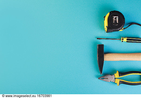 Tools worker  hammer  screwdriver  pliers on a blue background  top view