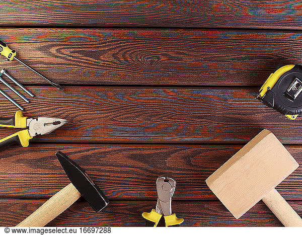 Tools worker  hammer  screwdriver  pliers on a wooden background  top view
