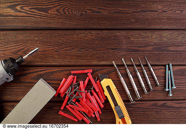 Tools worker  hammer  screwdriver  pliers on a wooden background  top view