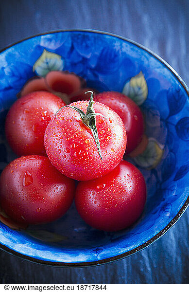 Top view of fresh tomatoes in blue bowl