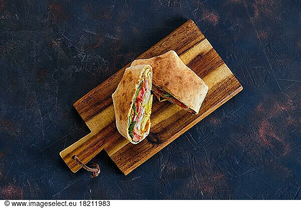 Top view of pita bread stuffed with ham  tomato and omelette