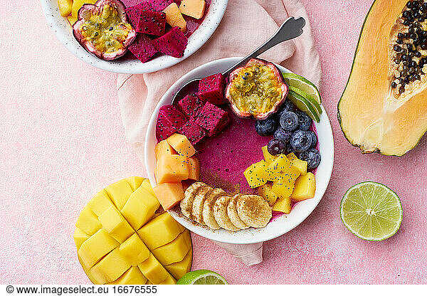 Top view smoothie bowl with dragon fruit  mango and papaya