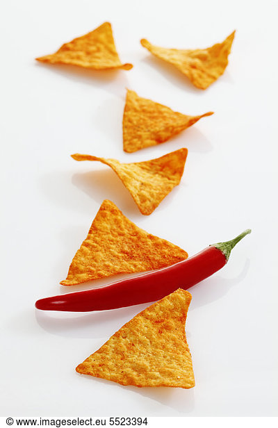 Tortilla chips with hot pepper in a row