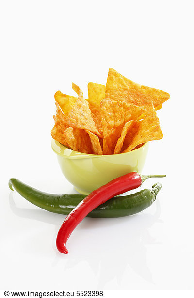 Tortilla chips with hot peppers in a plastic bowl