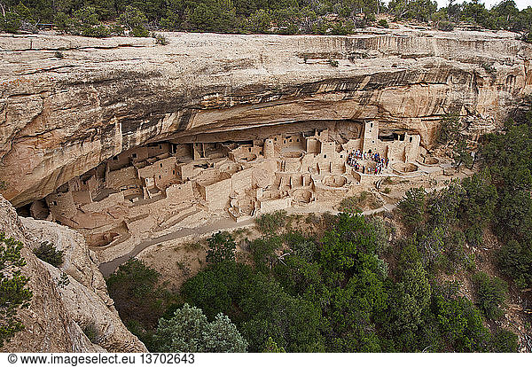 Tour group listening to a park ranger at Cliff Palace in Mesa Verde National Park. Mesa Verde is the largest archaeological preserve in the United States and Cliff Palace is the largest complex of dwellings within the park. Construction and refurbishing of Cliff Palace was continuous from around 1190 through 1260  and it was abandoned by 1300. The large square tower to the right was in ruins by the 1800s. The National Park Service carefully restored it to its approximate height and stature  using slightly different-colored materials to show it was a restoration. Mesa Verde is located in Montezuma County  Colorado.