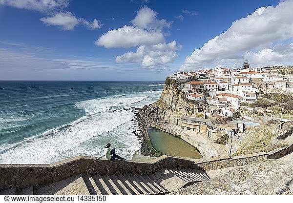 Tourist admires the perched village of Azenhas do Mar overlooking the Atlantic ocean  Sintra  Portugal  Europe