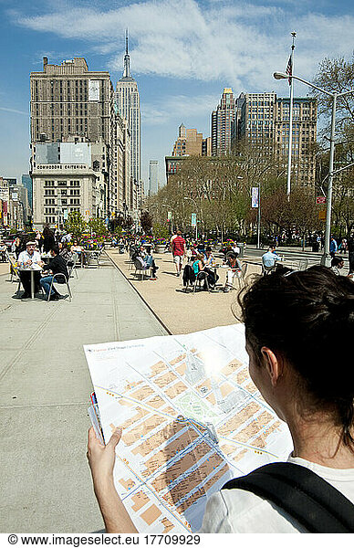 Tourist Girl Checking A Map In Madison Square Park  Manhattan  New York  Usa