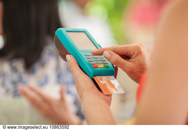 Tourist paying market trader with credit card
