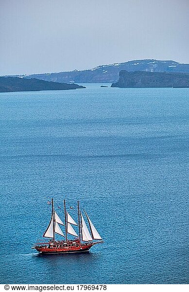 Tourist schooner vessel ship boat in Aegean sea near Santorini island with tourists going to sunset viewpoint  Santorini  Greece  Europe