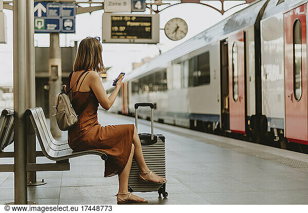 Tourist woman sitting in Antwerp train station