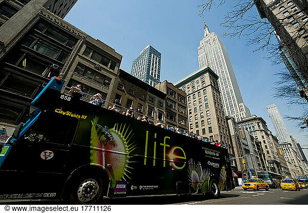 Touristic Bus Passing In Front Of The Empire State Building  Manhattan  New York  Usa