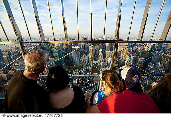 Tourists Enjoying The Views Of Manhattan From The Top Of The Empire State Building  New York  Usa